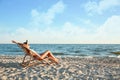 Young woman relaxing in deck chair Royalty Free Stock Photo