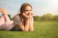Young woman relaxing on green grass outdoors Royalty Free Stock Photo