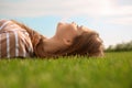 Young woman relaxing on green grass outdoors Royalty Free Stock Photo