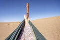 Young woman relaxing in green hammock with view on sand dunes of Sahara Desert, Morocco Royalty Free Stock Photo