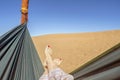 Young woman relaxing in green hammock with view on sand dunes of Sahara Desert, Morocco Royalty Free Stock Photo