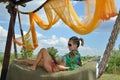 Young woman relaxing in hammock with tablet Royalty Free Stock Photo