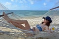 Young woman relaxing on a hammock on a tropical pacific island b