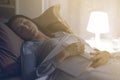 Woman falling asleep while reading a book