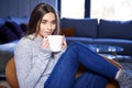 Young woman relaxing at home and having a cup of tea Royalty Free Stock Photo