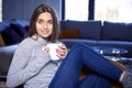 Young woman relaxing at home and having a cup of tea Royalty Free Stock Photo