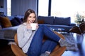 Young woman relaxing at home and having a cup of tea Royalty Free Stock Photo