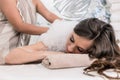 Young woman relaxing on hot marble bed during traditional Turkish bath Royalty Free Stock Photo