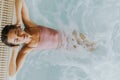 Young woman relaxing in the indoor swimming pool Royalty Free Stock Photo