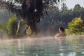 A young woman relaxing in an infinity pool