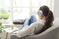 Woman relaxing on the couch and listening to music Royalty Free Stock Photo