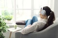 Woman relaxing on the couch and listening to music Royalty Free Stock Photo