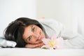 Young woman relaxing on massage table in spa