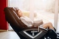 Young woman relaxing on the massaging chair Royalty Free Stock Photo