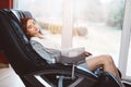 Young woman relaxing on the massaging chair Royalty Free Stock Photo