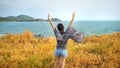 Young woman relaxing with meadow, sea, mountain, blue sky and cloud at Koh Sichang. Royalty Free Stock Photo