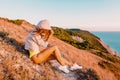 Young woman relaxing in nature at warm sunset. Fitness girl in the mountains Royalty Free Stock Photo