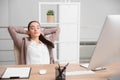 Young woman relaxing in office chair at workplace Royalty Free Stock Photo