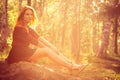 Young Woman relaxing outdoor in sunny forest Royalty Free Stock Photo