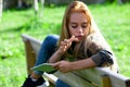 Young woman relaxing outdoors on a park bench Royalty Free Stock Photo