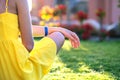 Young woman relaxing outdoors on sunny summer day. Happy lady sitting on green grass lawn daydreaming thinking. Calm girl enjoying Royalty Free Stock Photo