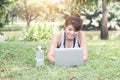 Young woman relaxing in the park, using a laptop on vacation day, Education and technology concept Royalty Free Stock Photo