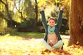 Young woman relaxing playing with leaves in autumn park Royalty Free Stock Photo