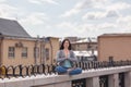 Young woman in a relaxing pose on the parapet