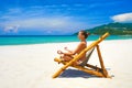 Young woman relaxing in pose yoga on a beautiful beach. Royalty Free Stock Photo