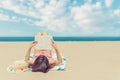 Young woman relaxing reading a book at the beach Royalty Free Stock Photo