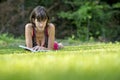 Young woman relaxing reading on the grass Royalty Free Stock Photo