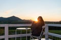 Young Woman Relaxing On Roof Terrace With Cup Of Coffee Royalty Free Stock Photo