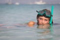 Young woman relaxing in sea with snorkel and mask.