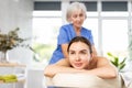 Young woman relaxing in spa center during professional back massage Royalty Free Stock Photo