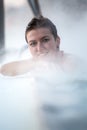 Young woman relaxing in thermal pool. Royalty Free Stock Photo