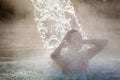 Young woman relaxing in thermal pool. Royalty Free Stock Photo