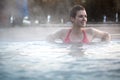 Young woman relaxing in thermal pool. Royalty Free Stock Photo