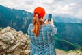 Young woman hiker use smartphone taking photo on seaside mountain top Royalty Free Stock Photo