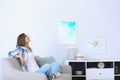 Young woman relaxing under air conditioner