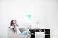 Young woman relaxing under air conditioner Royalty Free Stock Photo