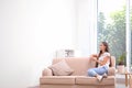 Young woman relaxing under air conditioner Royalty Free Stock Photo