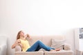 Young woman relaxing under air conditioner Royalty Free Stock Photo