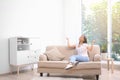 Young woman relaxing under air conditioner Royalty Free Stock Photo