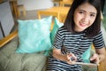 Young woman relaxing using tablet smile looking at camera