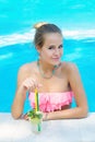 Young woman relaxiwith refreshing lemonade in the pool Royalty Free Stock Photo