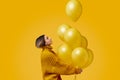 Young woman releasing balloons Royalty Free Stock Photo