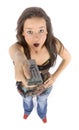 Young woman with remote control looks shocked Royalty Free Stock Photo