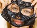 Girl removes black mask from face Royalty Free Stock Photo