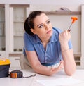 Young woman repairing chair at home