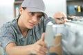 young woman repairing electronic appliance